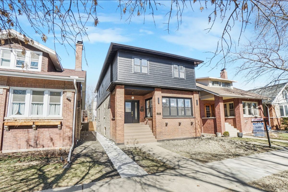 Brick front elevation and entry on a bungalow block. The housing stock in Portage Park and Old Irving is mostly brick bungalows.