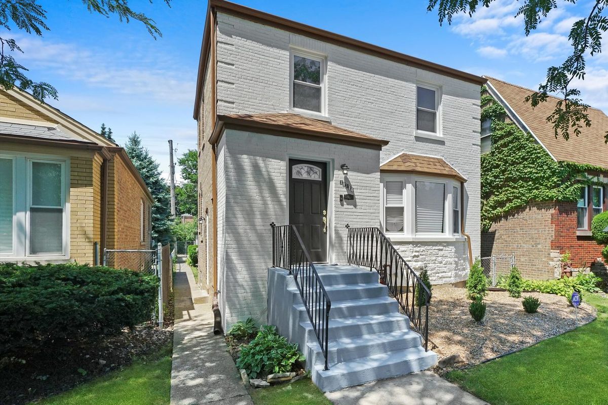 Restored brick two-flat, bay window and limestone base. The housing stock in North Lawndale and Little Village is mostly brick two-flats.
